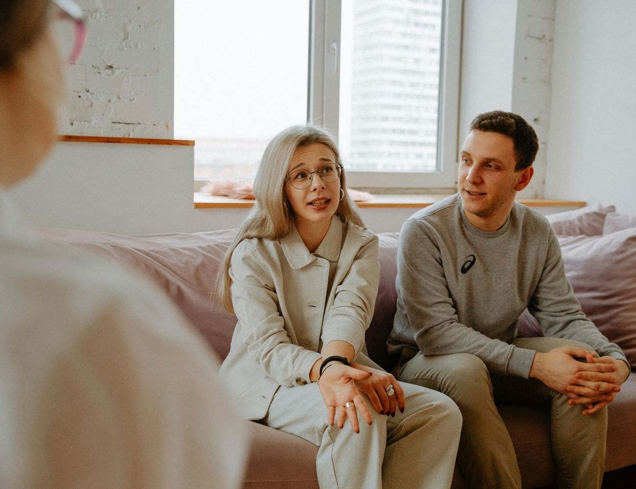 A man and woman sitting on top of a couch.